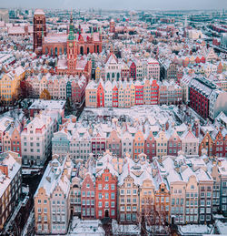 High angle view of snow covered buildings in city