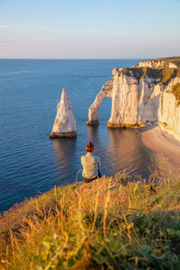 Scenic view of rocks in sea against sky