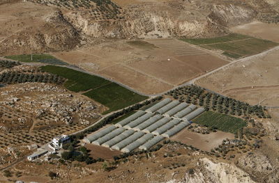 Aerial view of greenhouses and field