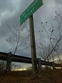 Sign board against sky at night