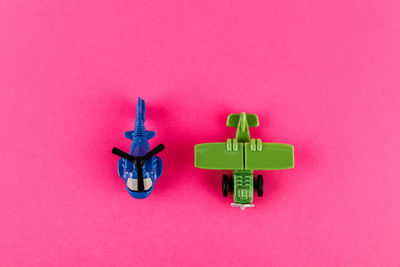 Close-up of toys against pink wall