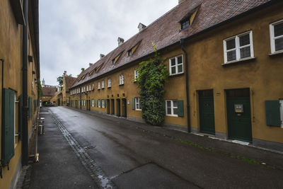 Street amidst buildings against sky