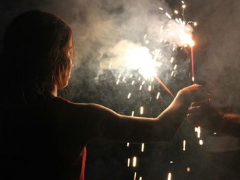 People celebrating with firecracker at night