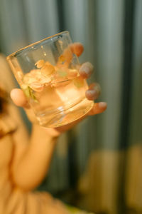 Cropped hand holding wineglass