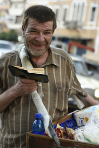 Portrait of smiling man in city