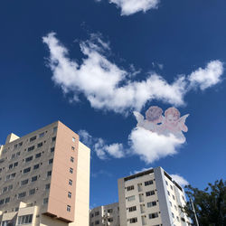 Low angle view of buildings against blue sky