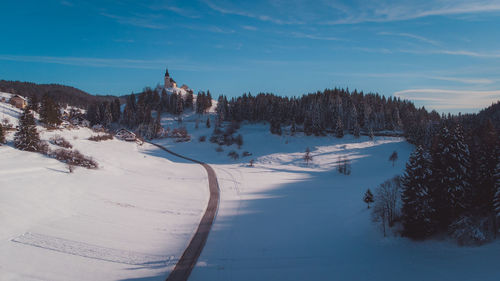 Scenic view of snow covered landscape against sky