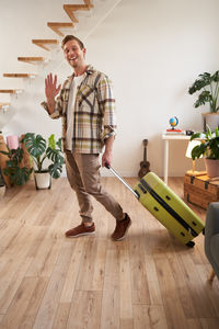 Full length of man standing on hardwood floor