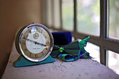 Close-up of clock on table