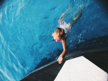 High angle view of boy swimming in pool
