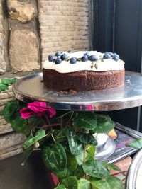 Close-up of cake with ice cream cone against stone wall