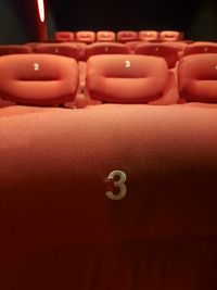 Midsection of woman standing against black background