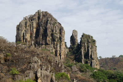 Low angle view of rock formation against sky