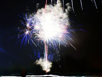 Low angle view of firework display at night