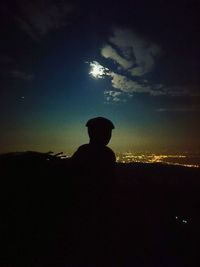 Silhouette man standing against sky during sunset