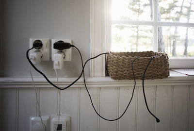 Electrical outlets by wicker basket on window sill