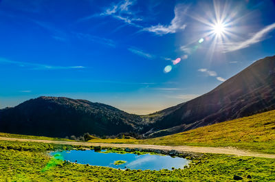 Scenic view of mountains against blue sky