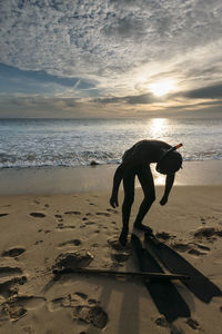 Silhouette scuba diver at beach