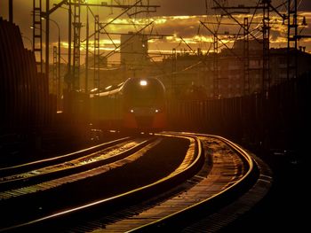 Railroad tracks in city at night