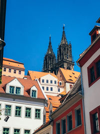 Low angle view of buildings against blue sky