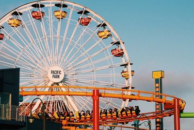 Low angle view of ferris wheel against sky