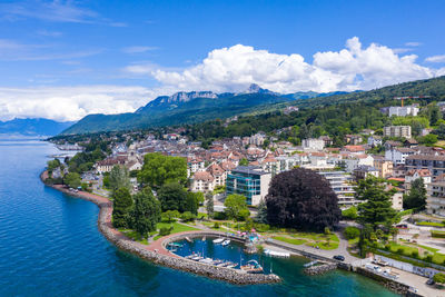 Panoramic view of bay and buildings against sky