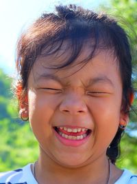 Close-up of cheerful girl with closed eyes