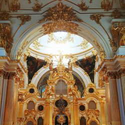 Interior of illuminated cathedral against sky