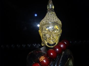 Close-up of illuminated lighting equipment against black background