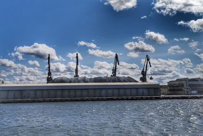 Panoramic view of bridge over river against blue sky