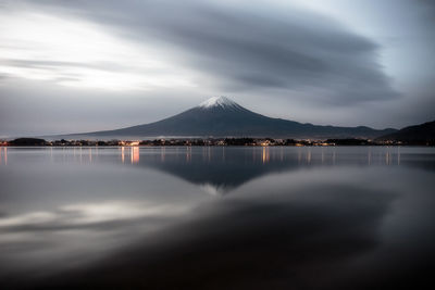 Scenic view of lake by snowcapped mountain 