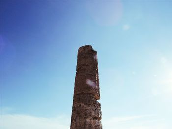 Low angle view of old ruin against blue sky