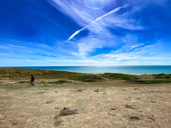 Scenic view of landscape against blue sky
