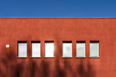 Low angle view of orange building against sky