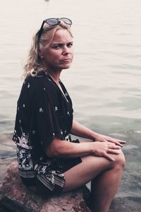 Portrait of woman sitting in lake