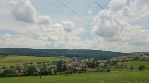 Scenic view of green landscape against sky