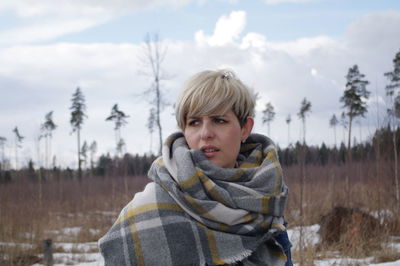 Portrait of young man on snow covered land