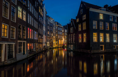 Reflection of buildings in city at night