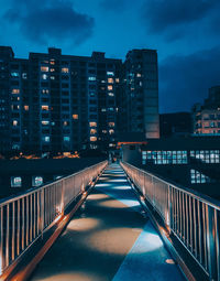 Illuminated buildings against sky at night