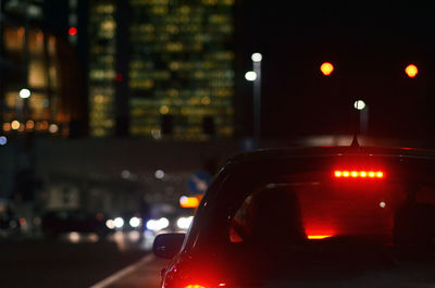 Close-up of illuminated car on city at night