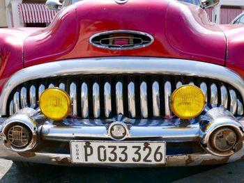 Close-up of yellow car on street