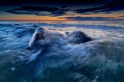 Scenic view of sea against sky at sunset