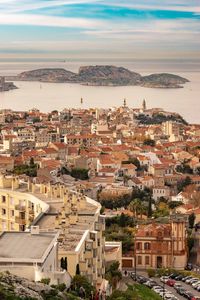 Aerial view of townscape by sea