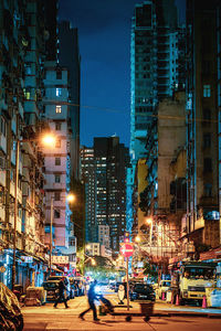 Illuminated city street and buildings at night