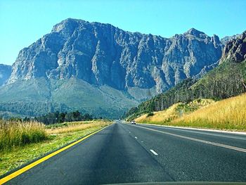 Country road leading towards mountains