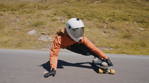 Man riding motor scooter on road