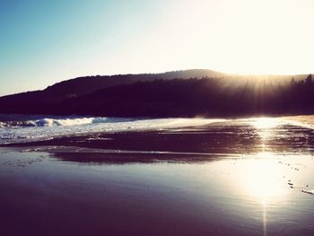 Scenic view of sea against clear sky during sunset