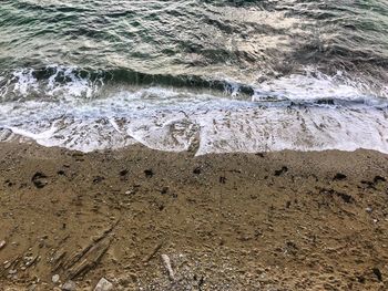 High angle view of water flowing on beach