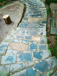 High angle view of stone on footpath by street