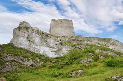 Low angle view of rock formation against sky